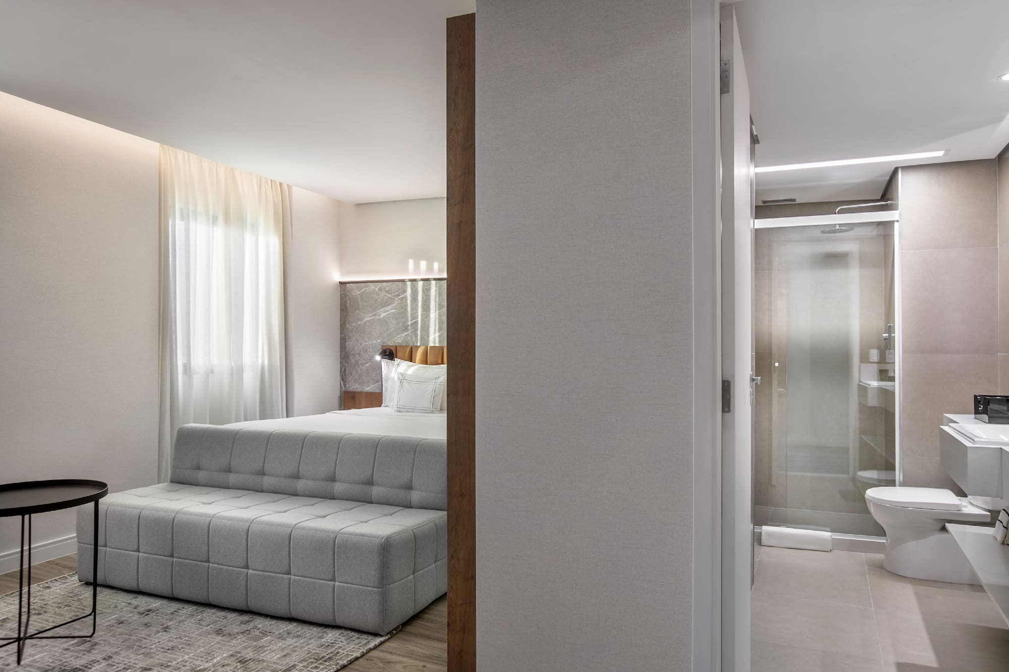 a bedroom with a bed and a shower