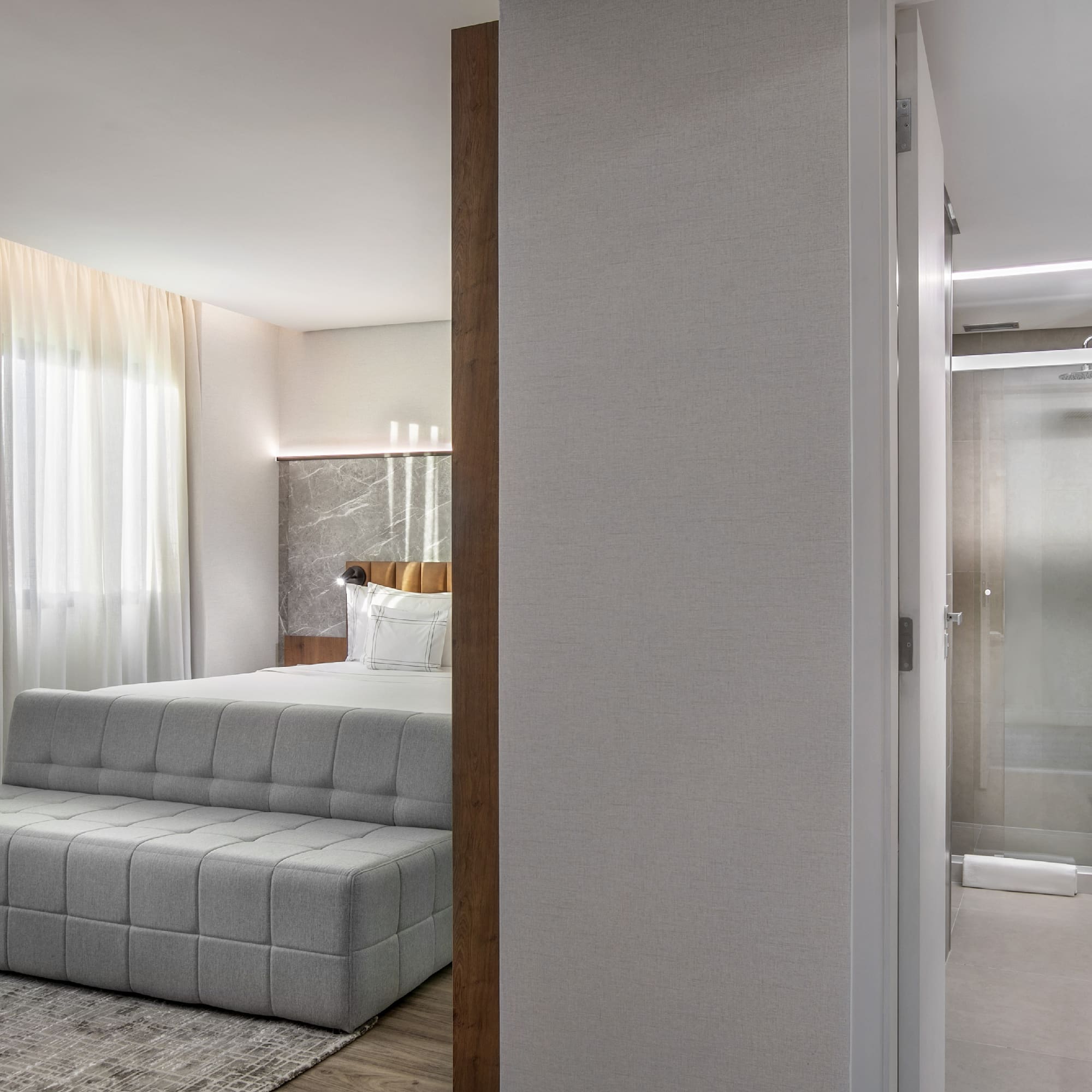 a bedroom with a bed and a shower