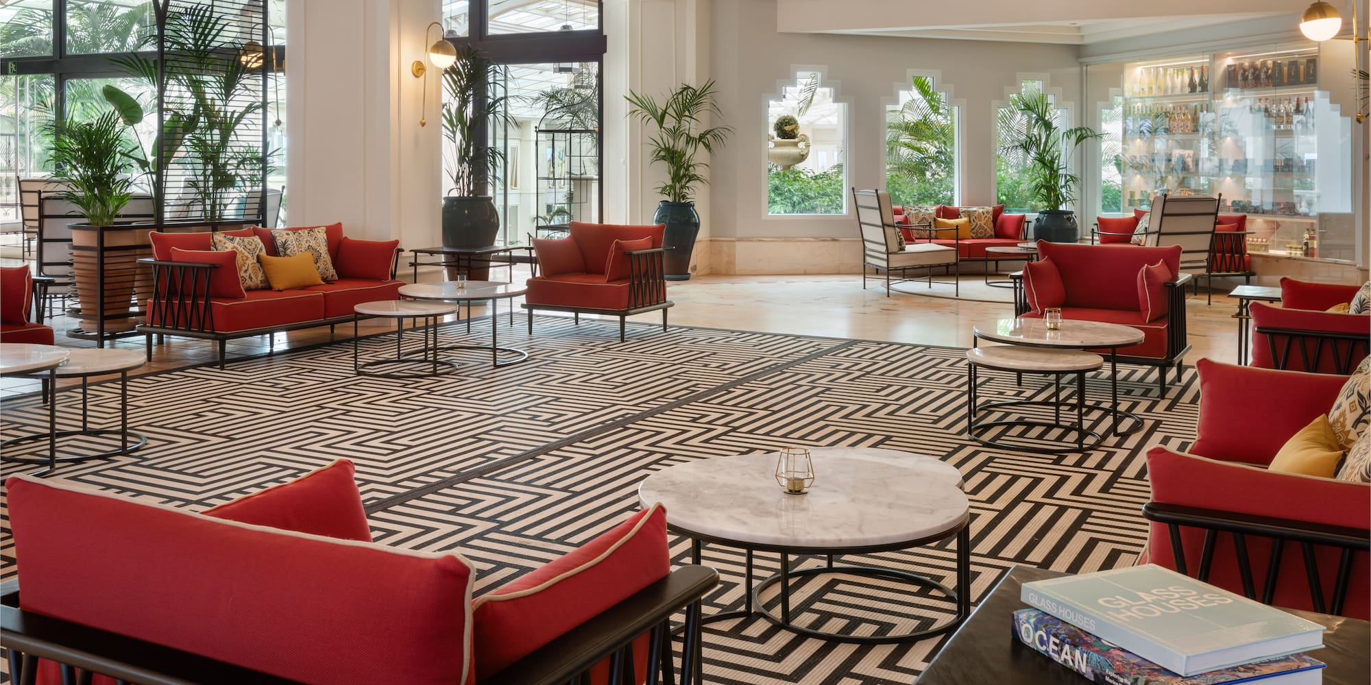 a room with red couches and tables