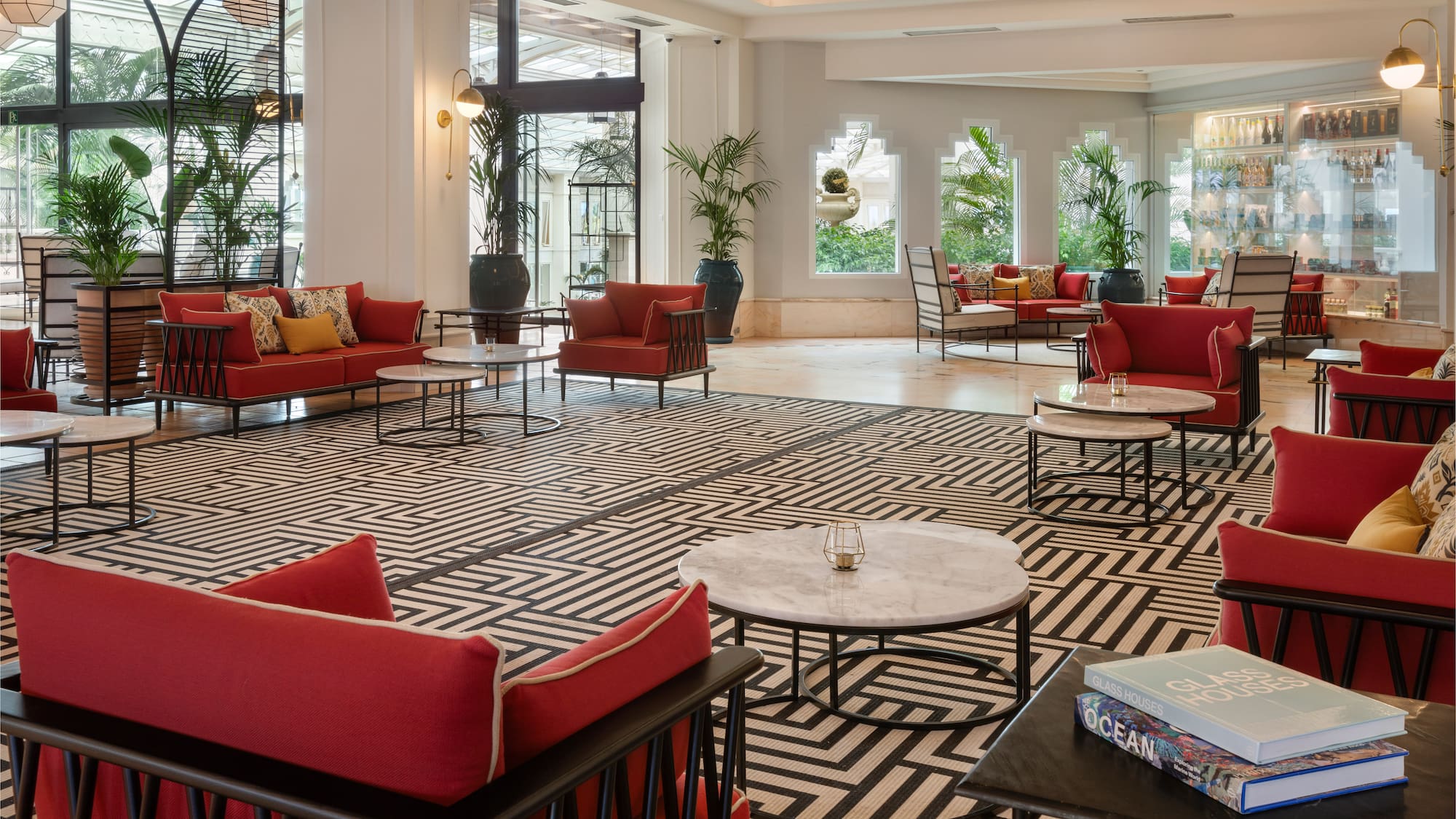 a room with red couches and tables