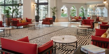 a room with red couches and tables