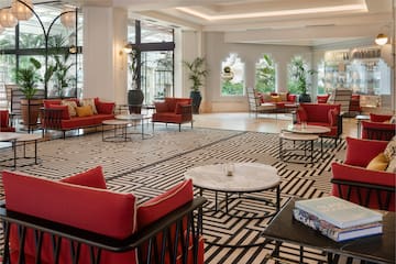 a room with red couches and tables
