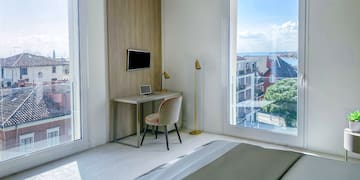 a bedroom with a desk and a bed
