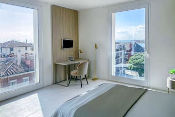 a bedroom with a desk and a bed