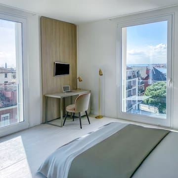 a bedroom with a desk and a bed