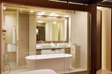 a bathroom with a tub and a mirror