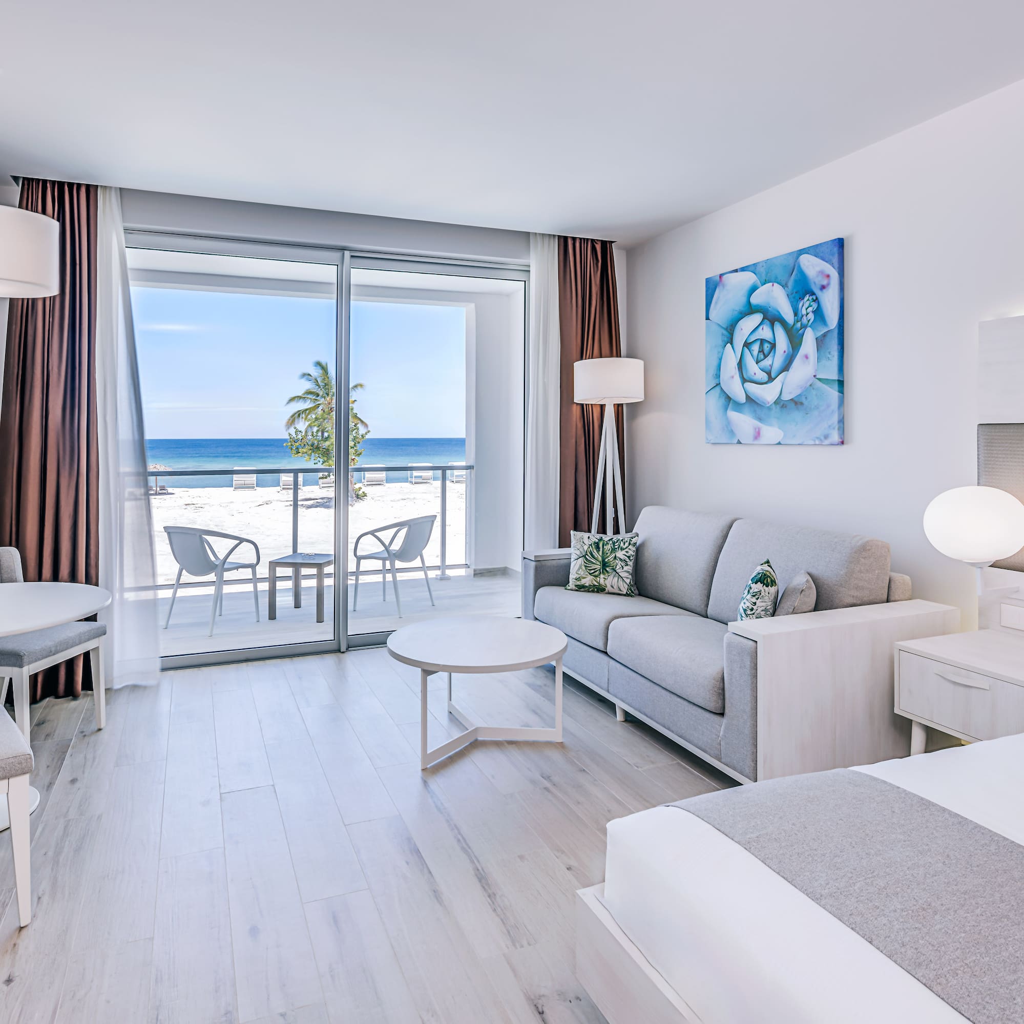 a room with a view of the ocean and a beach