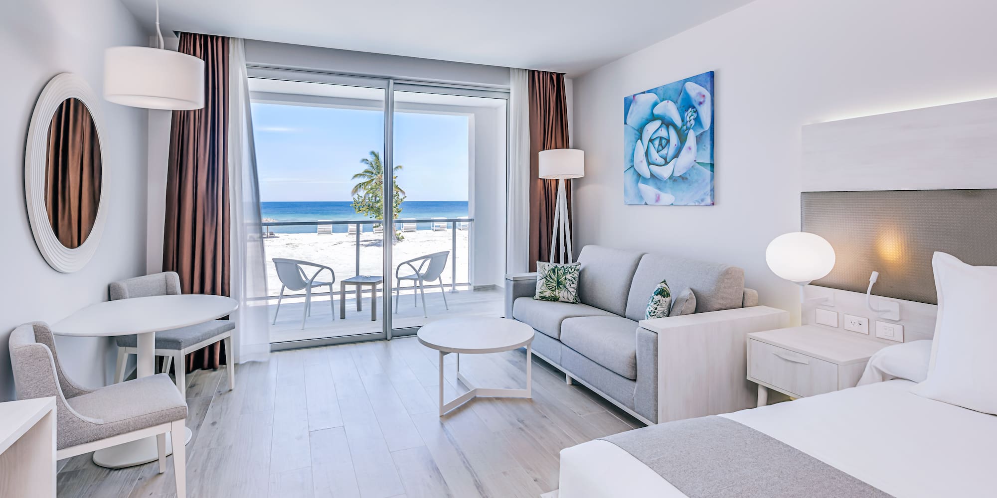 a room with a view of the ocean and a beach