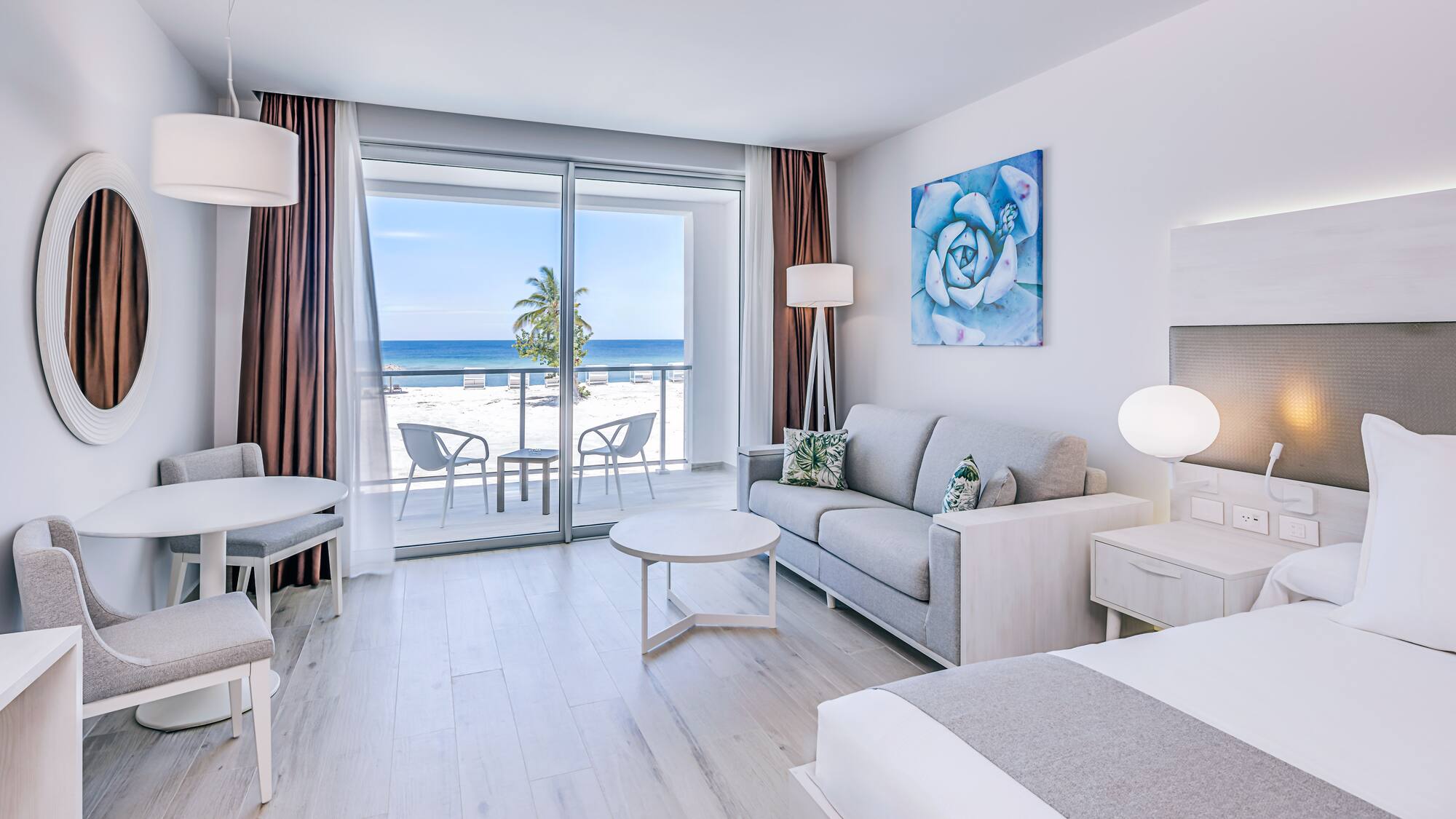 a room with a view of the ocean and a beach