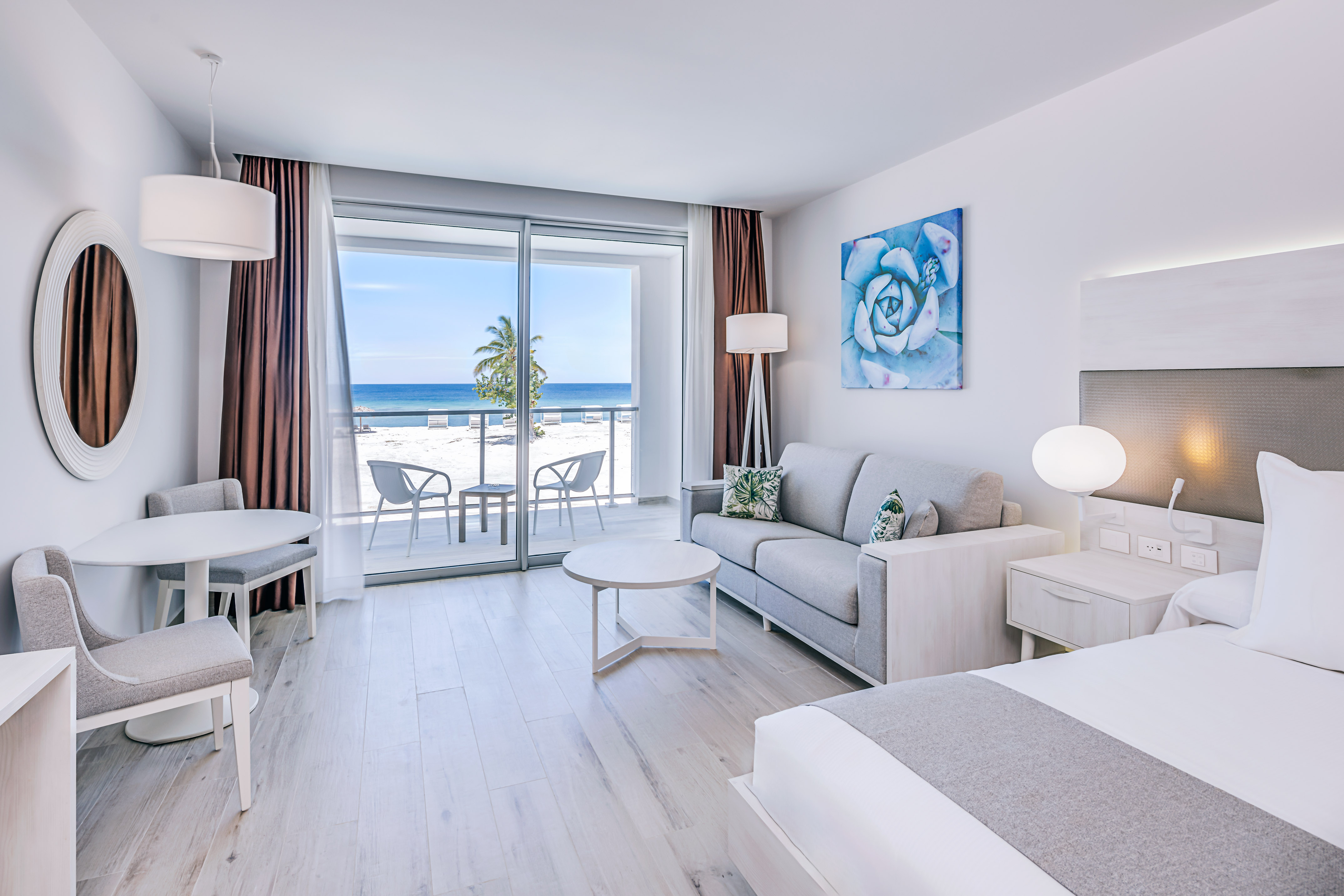 a room with a view of the ocean and a beach