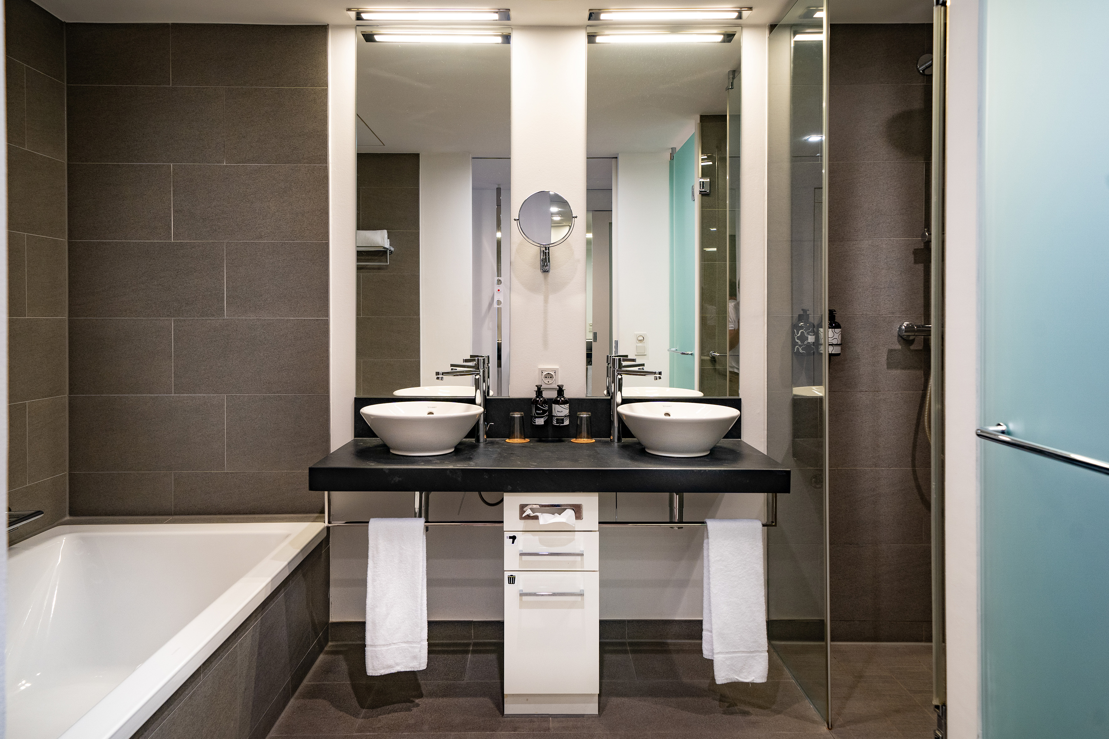 a bathroom with a shower and sink