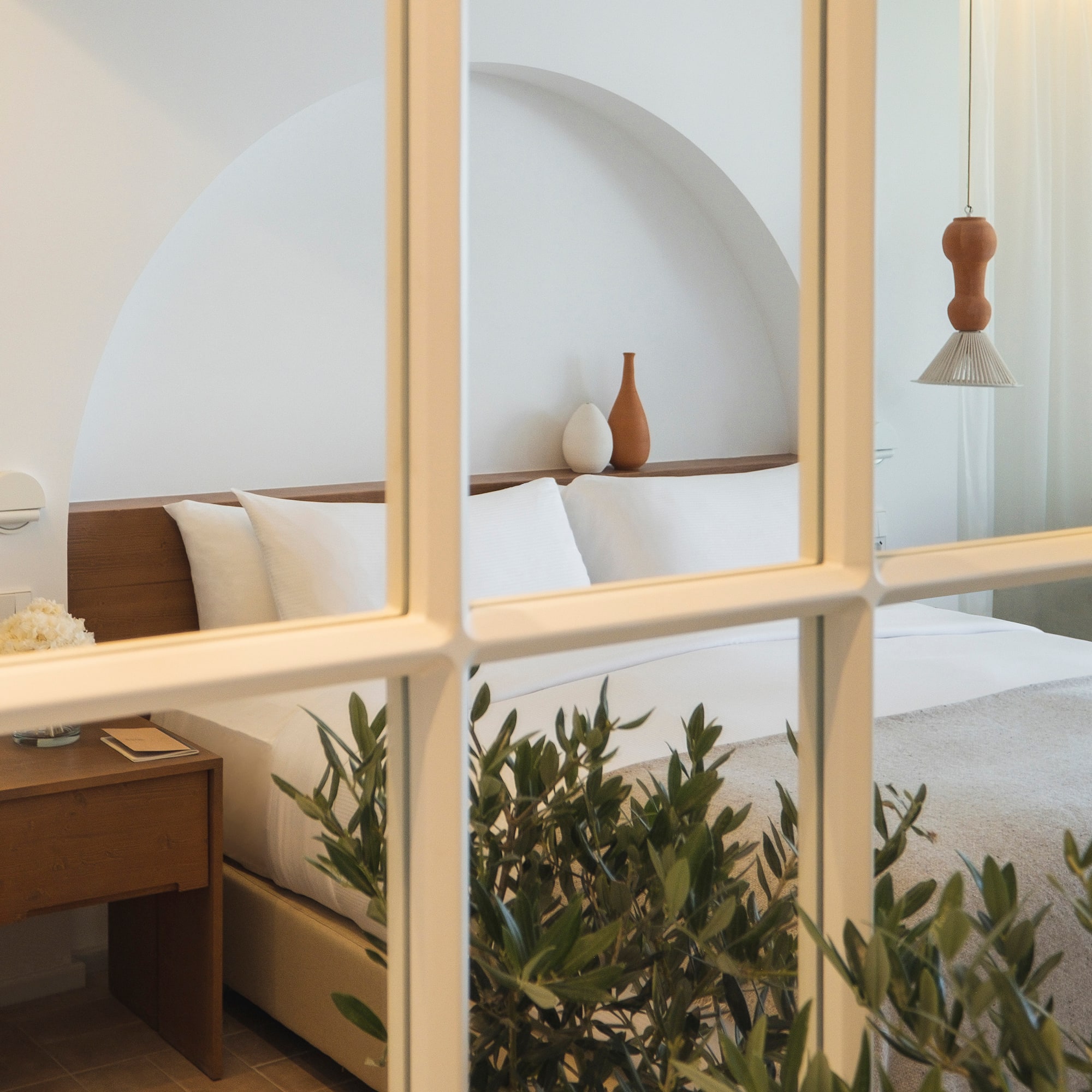 a window with a bed and plant