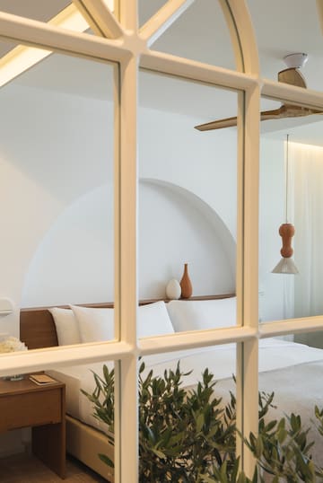 a window with a bed and plant