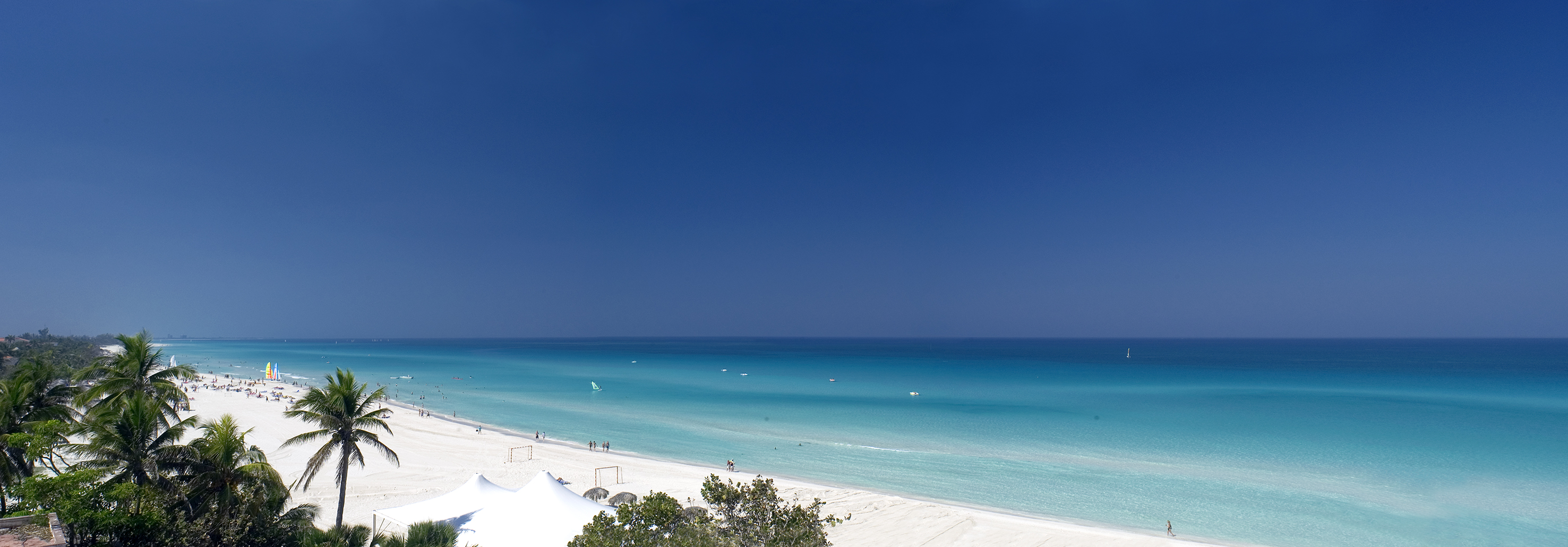 a beach with white sand and blue water