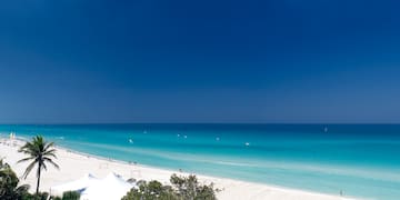 a beach with white sand and blue water