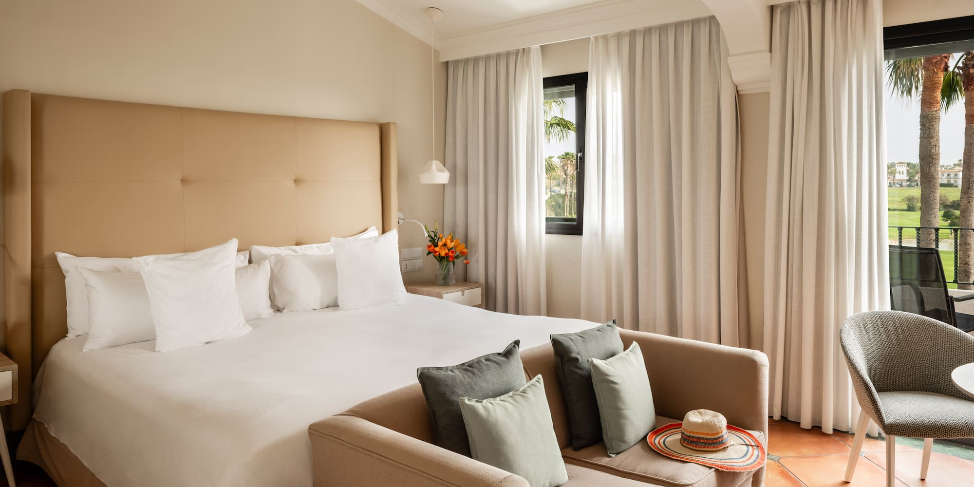 a bed with pillows and a couch in a room