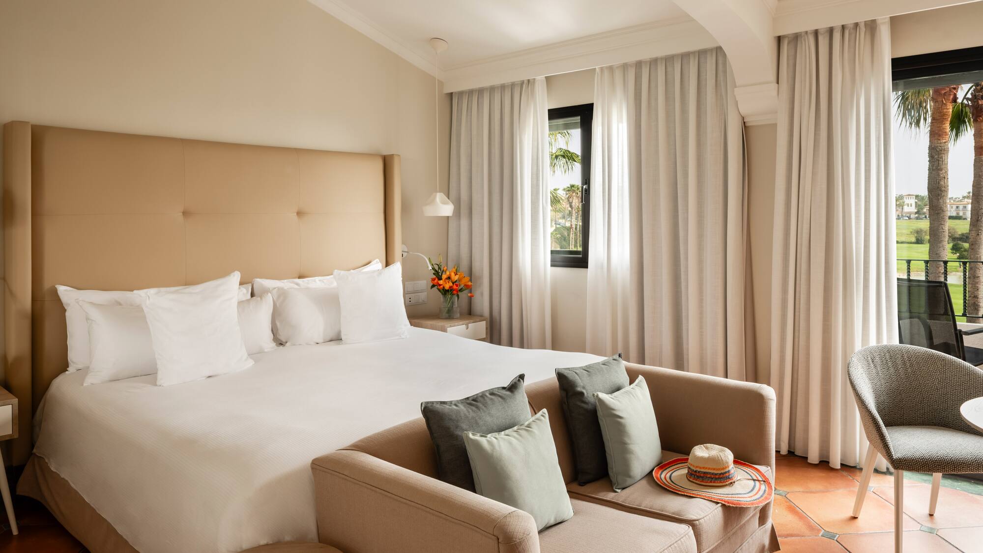 a bed with pillows and a couch in a room