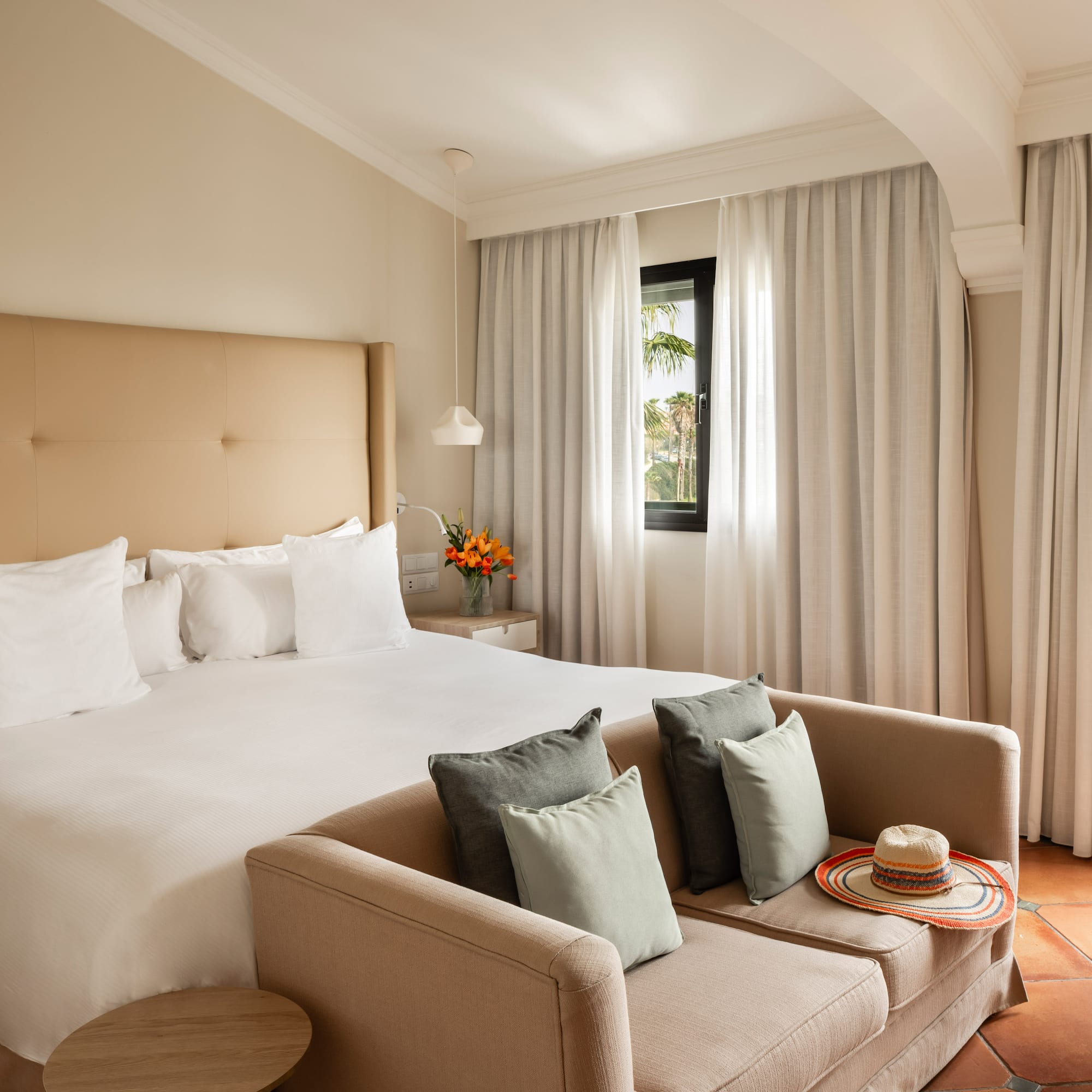 a bed with pillows and a couch in a room