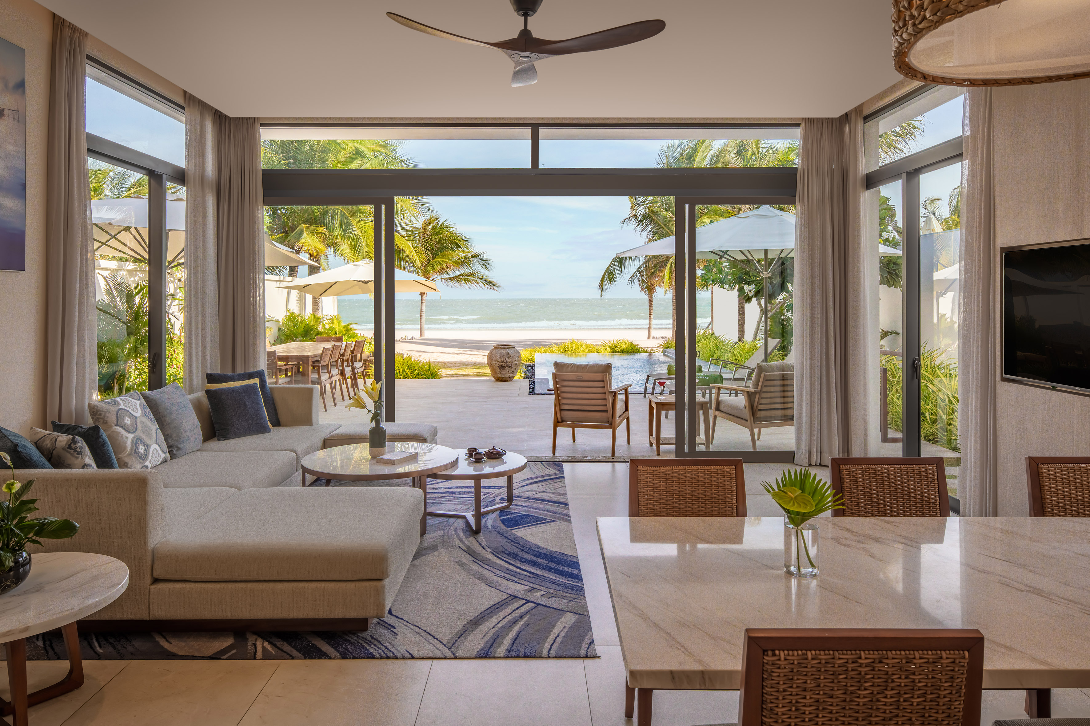 a living room with a large glass door and a large couch