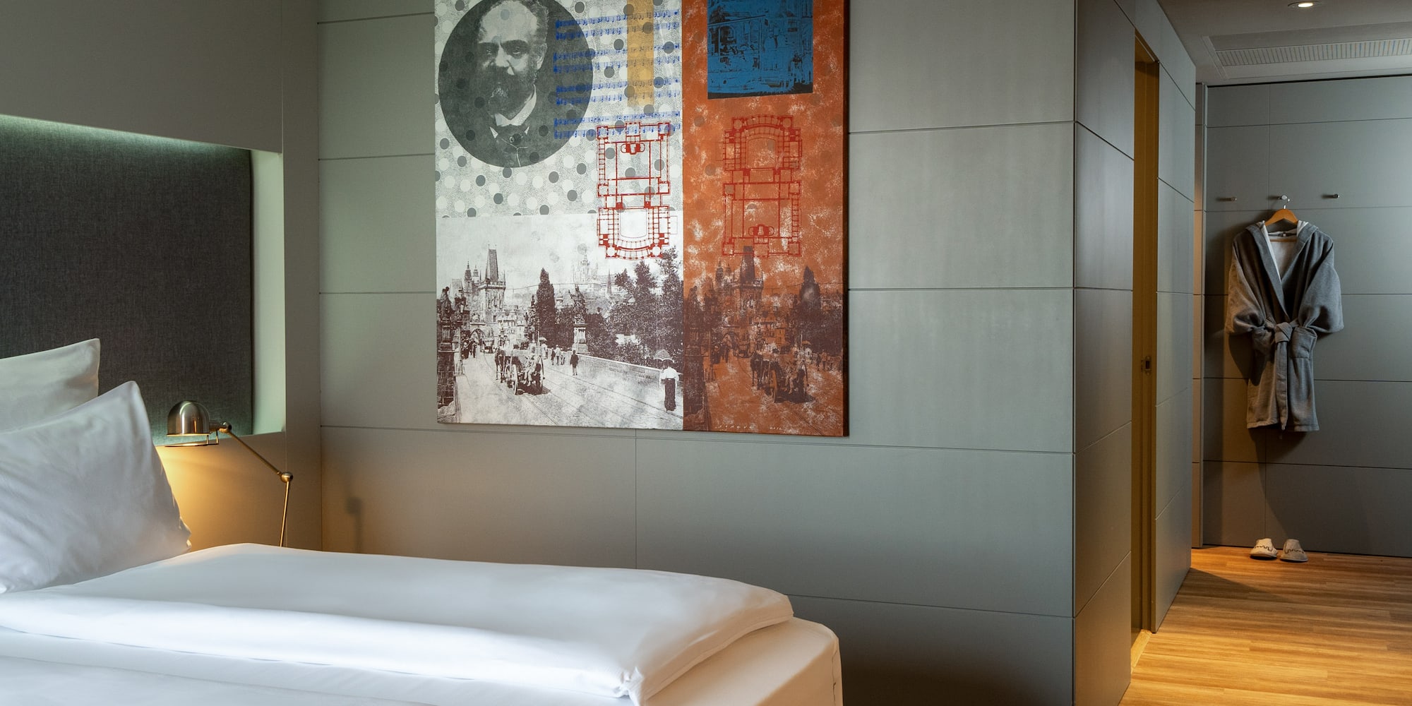 a bed with a painting on the wall