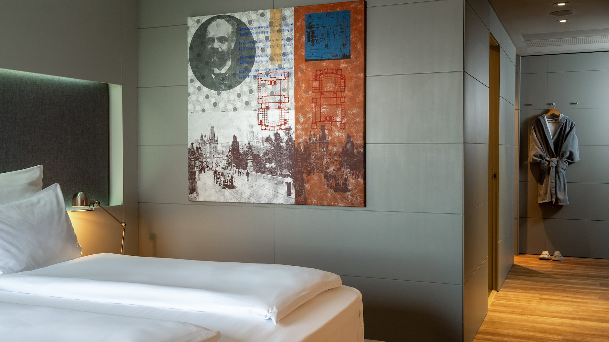 a bed with a painting on the wall