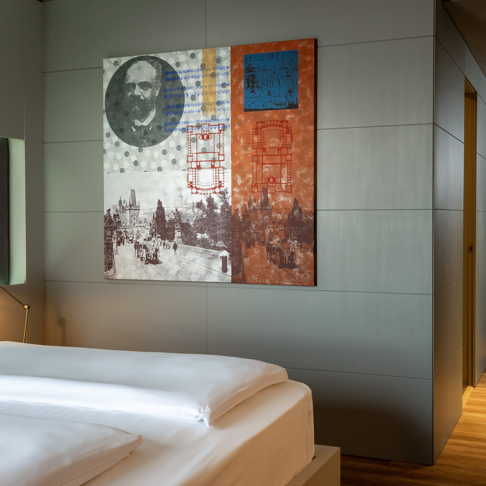 a bed with a painting on the wall