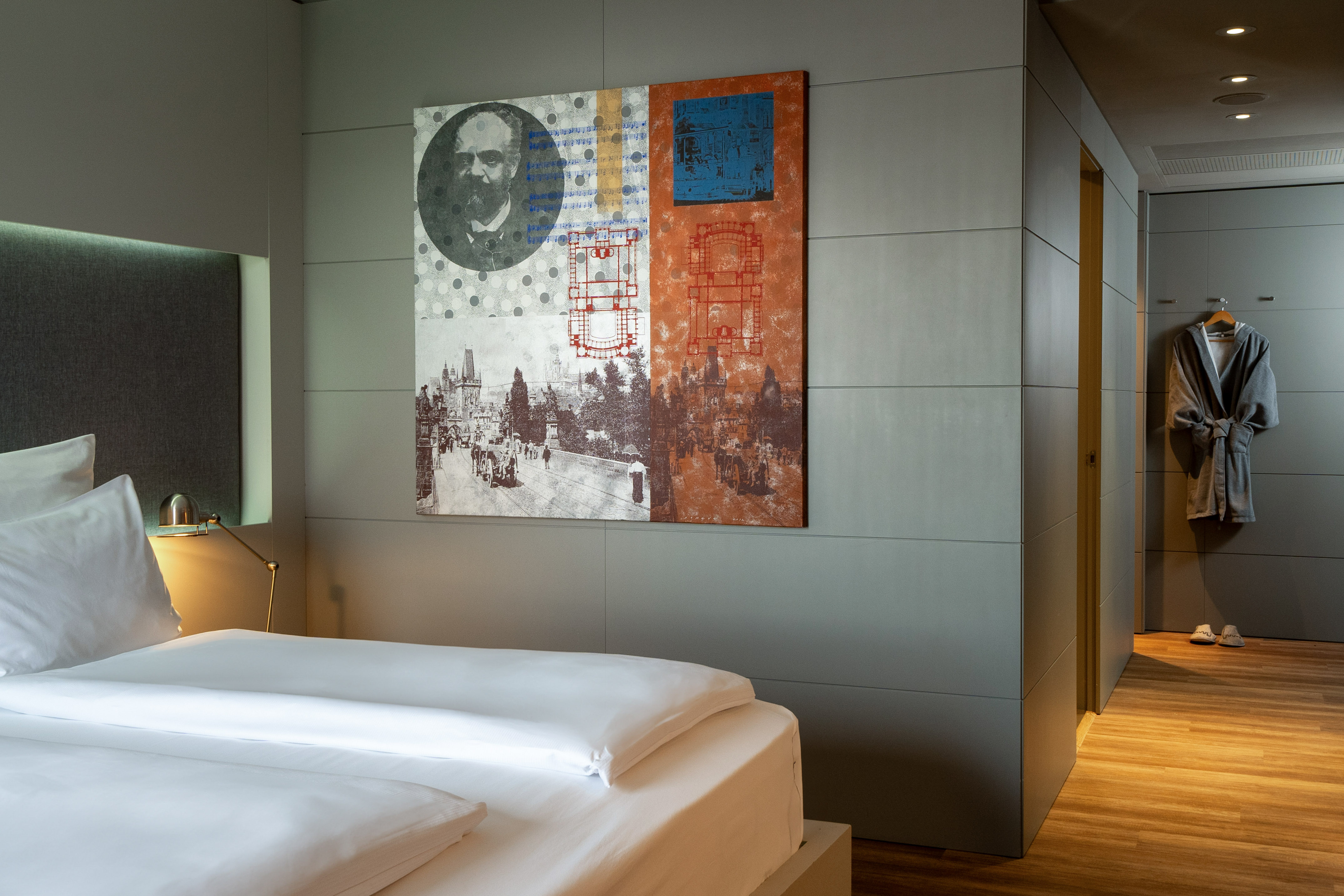 a bed with a painting on the wall