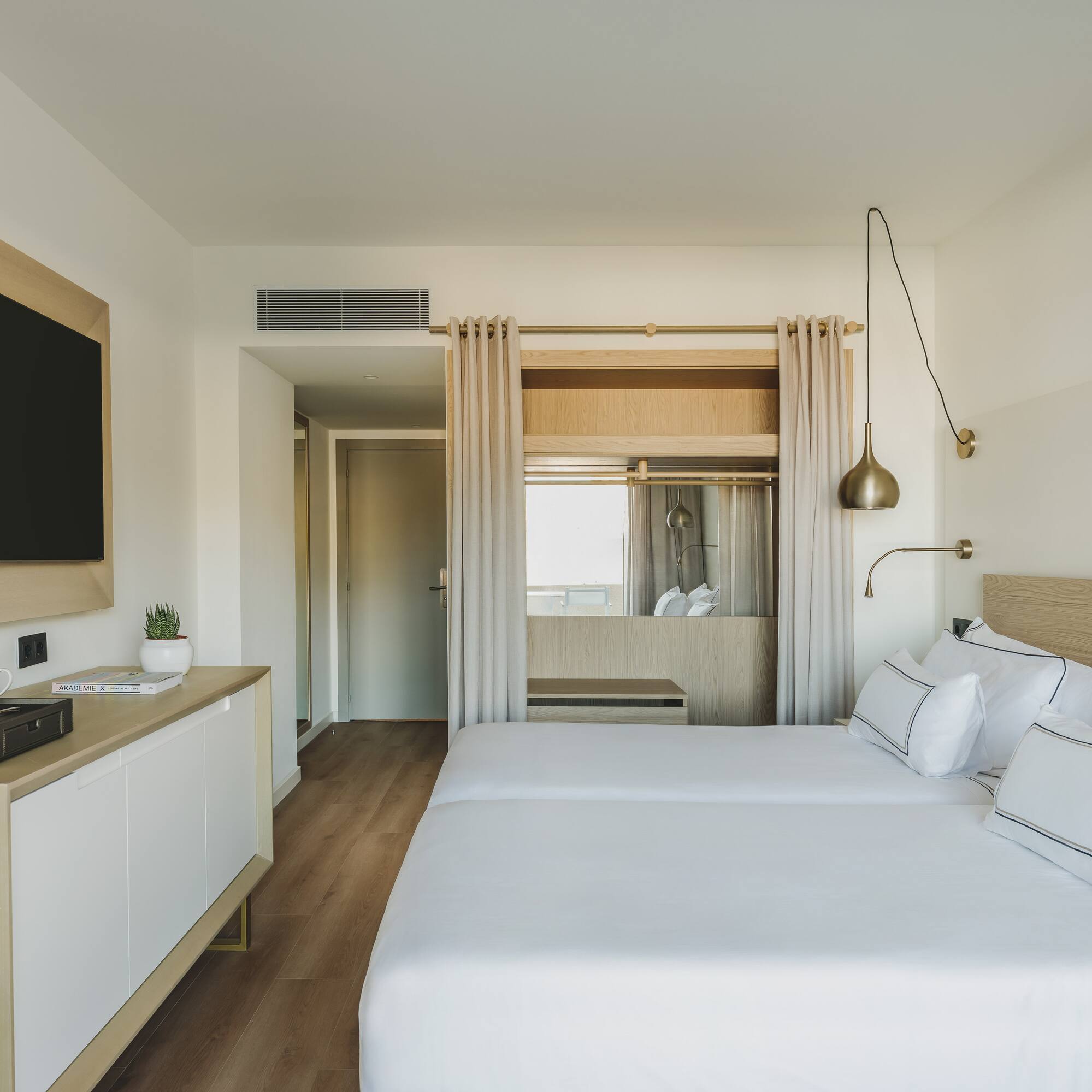 a room with a bed and a television