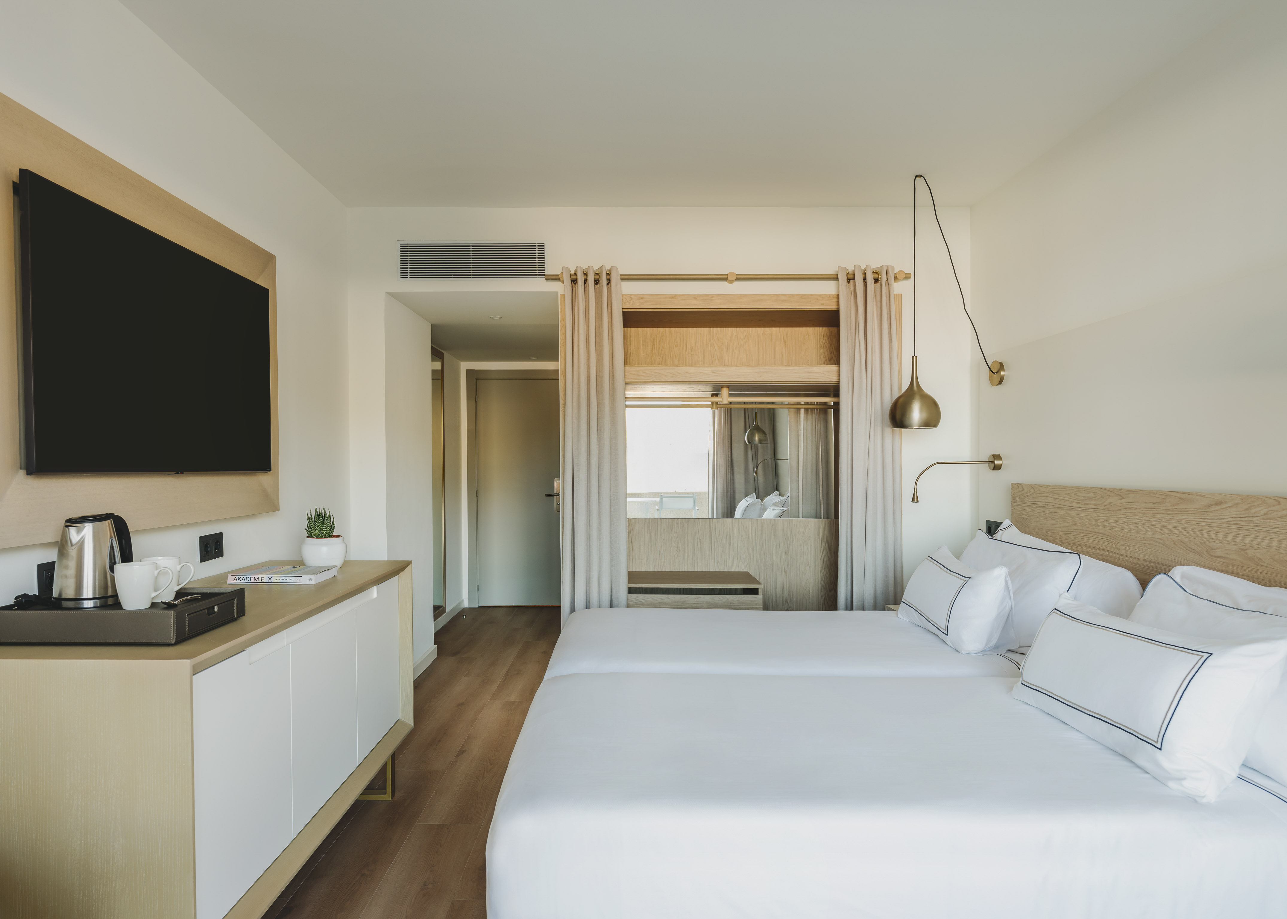 a room with a bed and a television