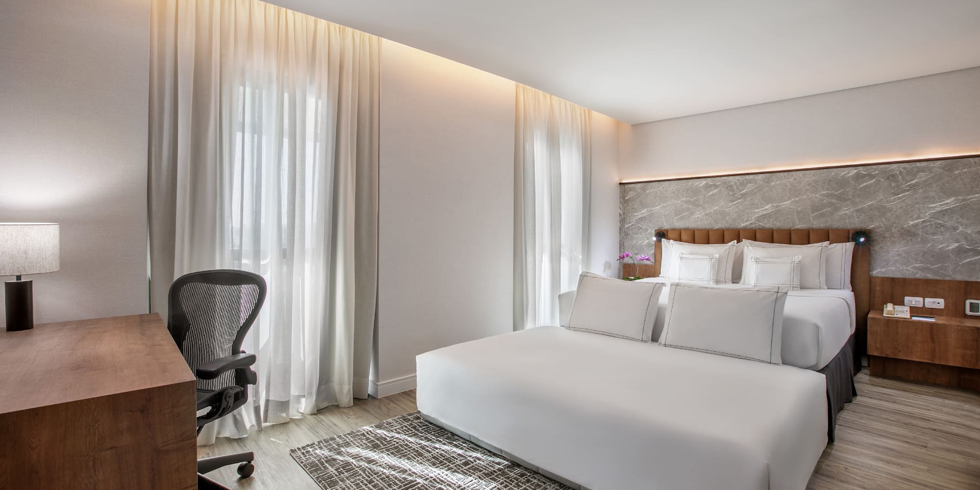 a room with a bed and a desk