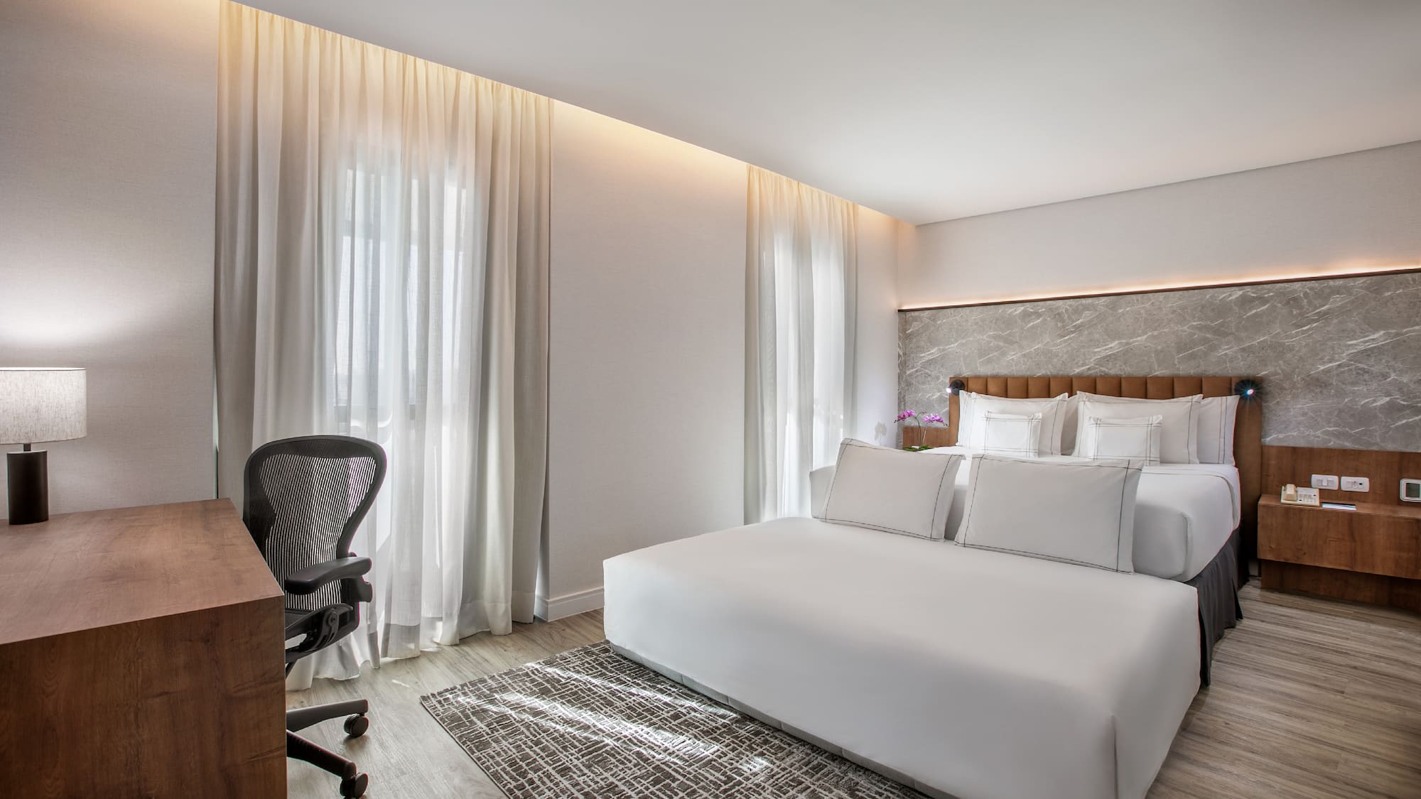 a room with a bed and a desk