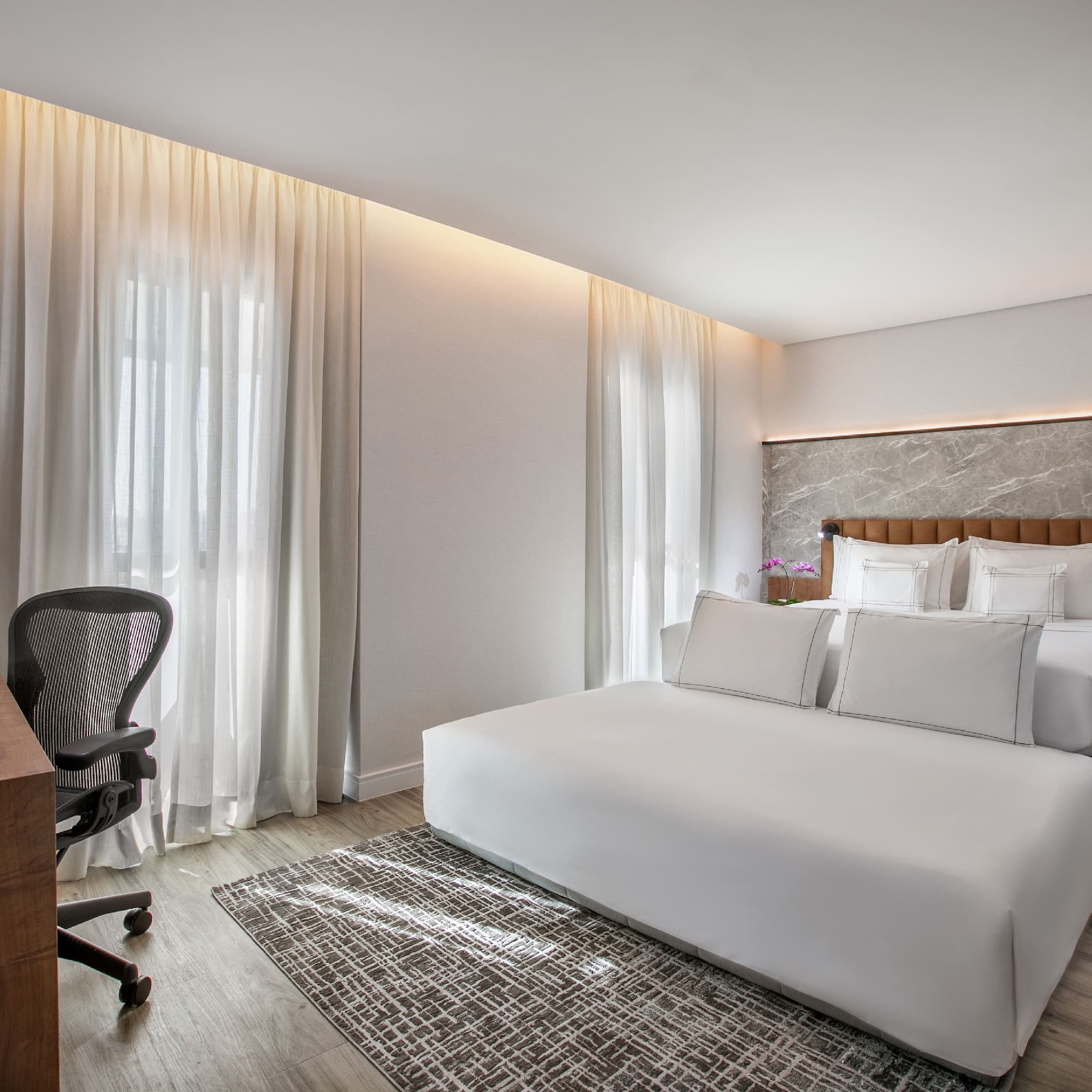 a room with a bed and a desk