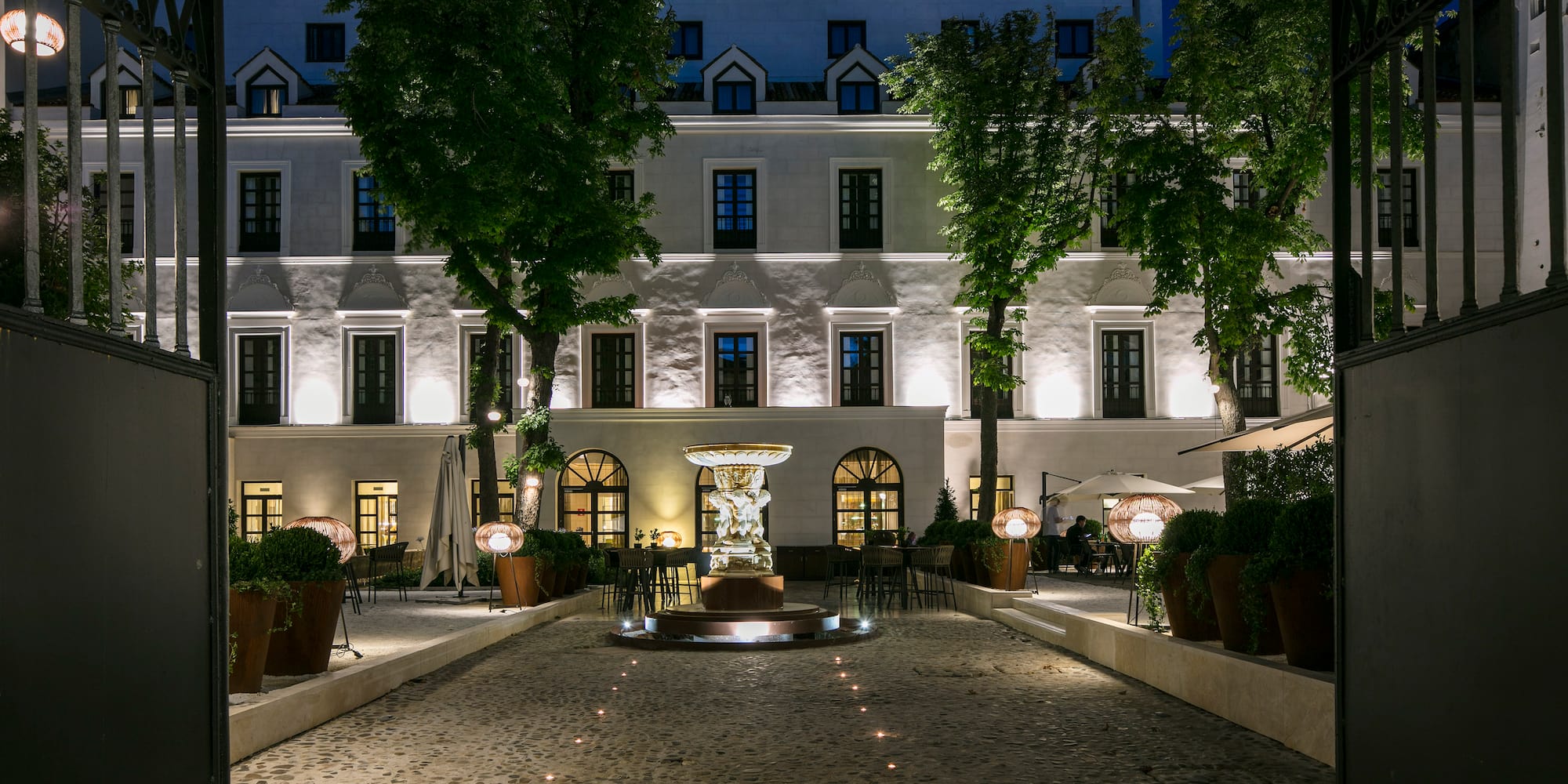 a building with a fountain and trees