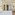 Stylish hotel suite with comfortable bed, sofa, wall art, and warm lighting.