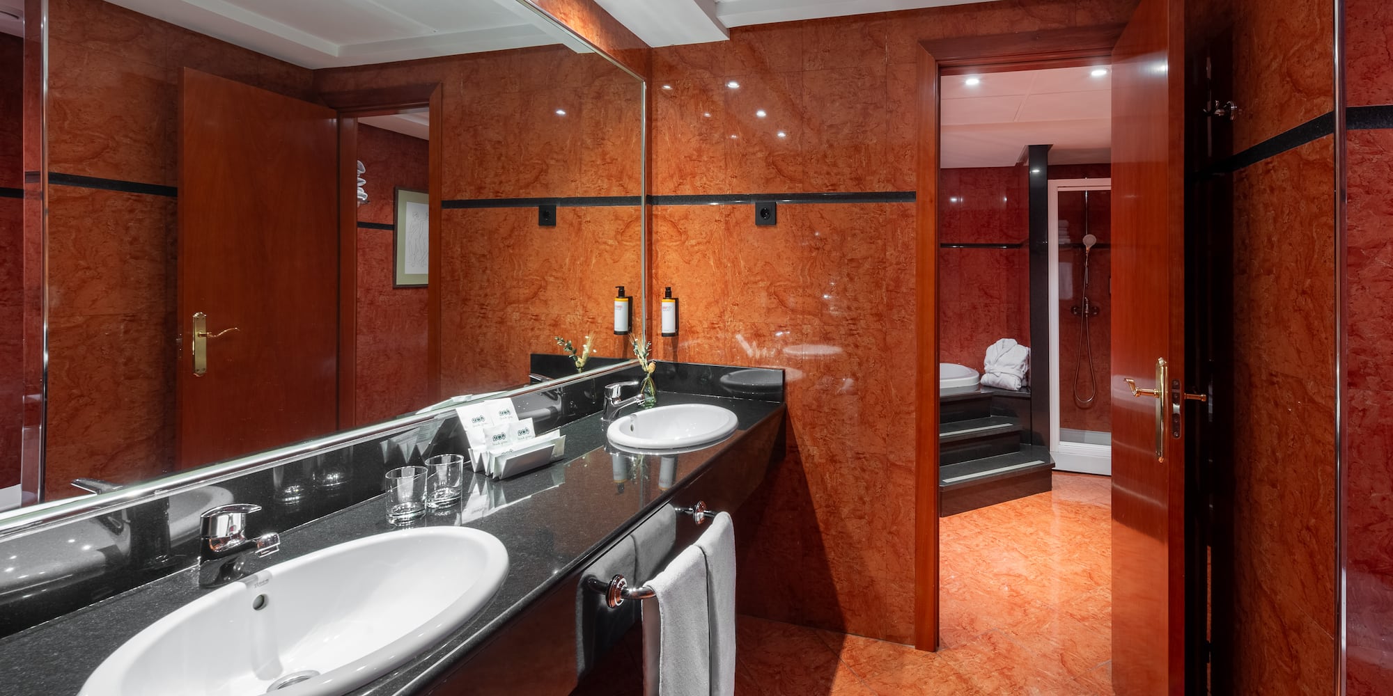a bathroom with a marble countertop and a large mirror