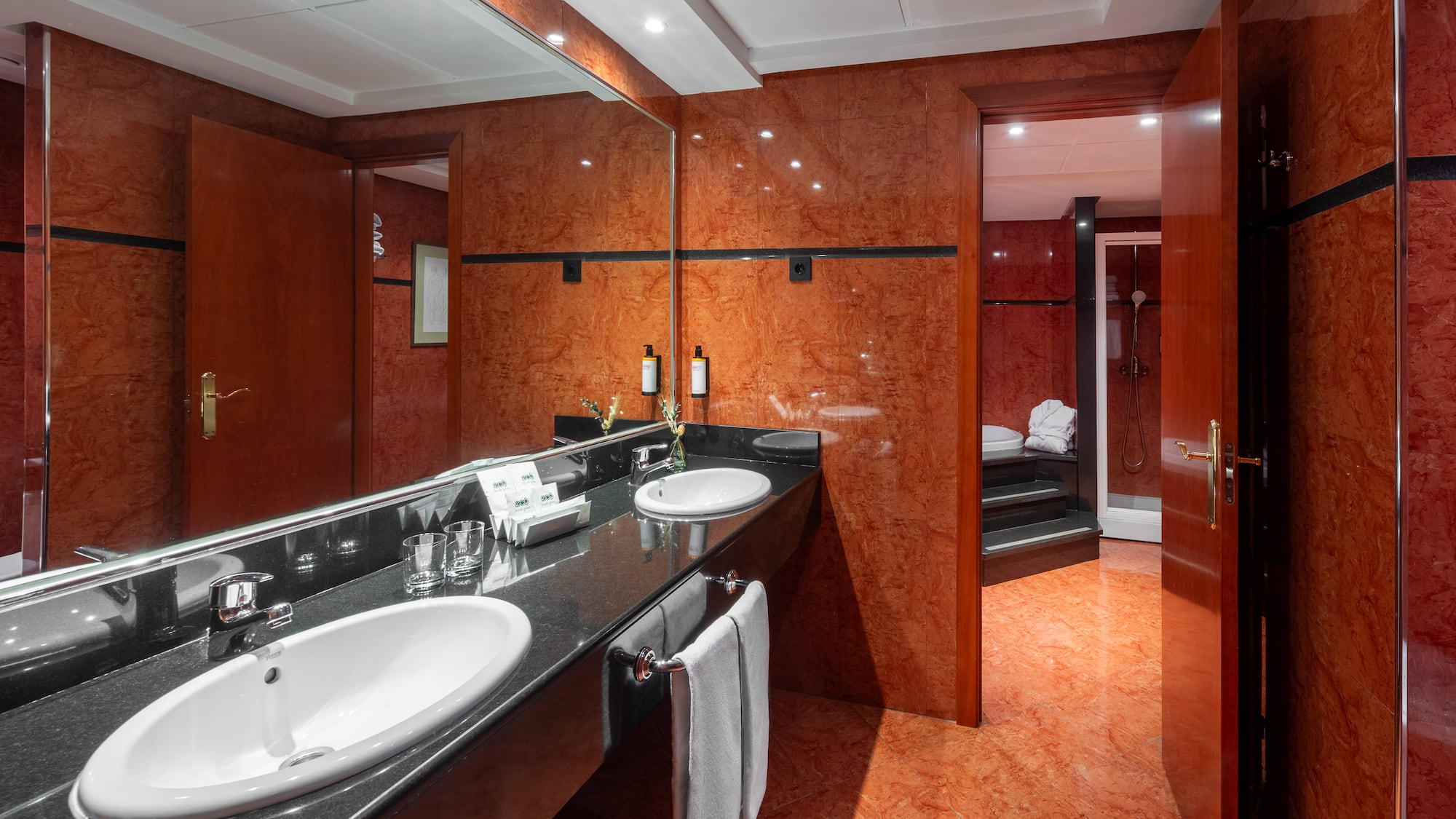 a bathroom with a marble countertop and a large mirror
