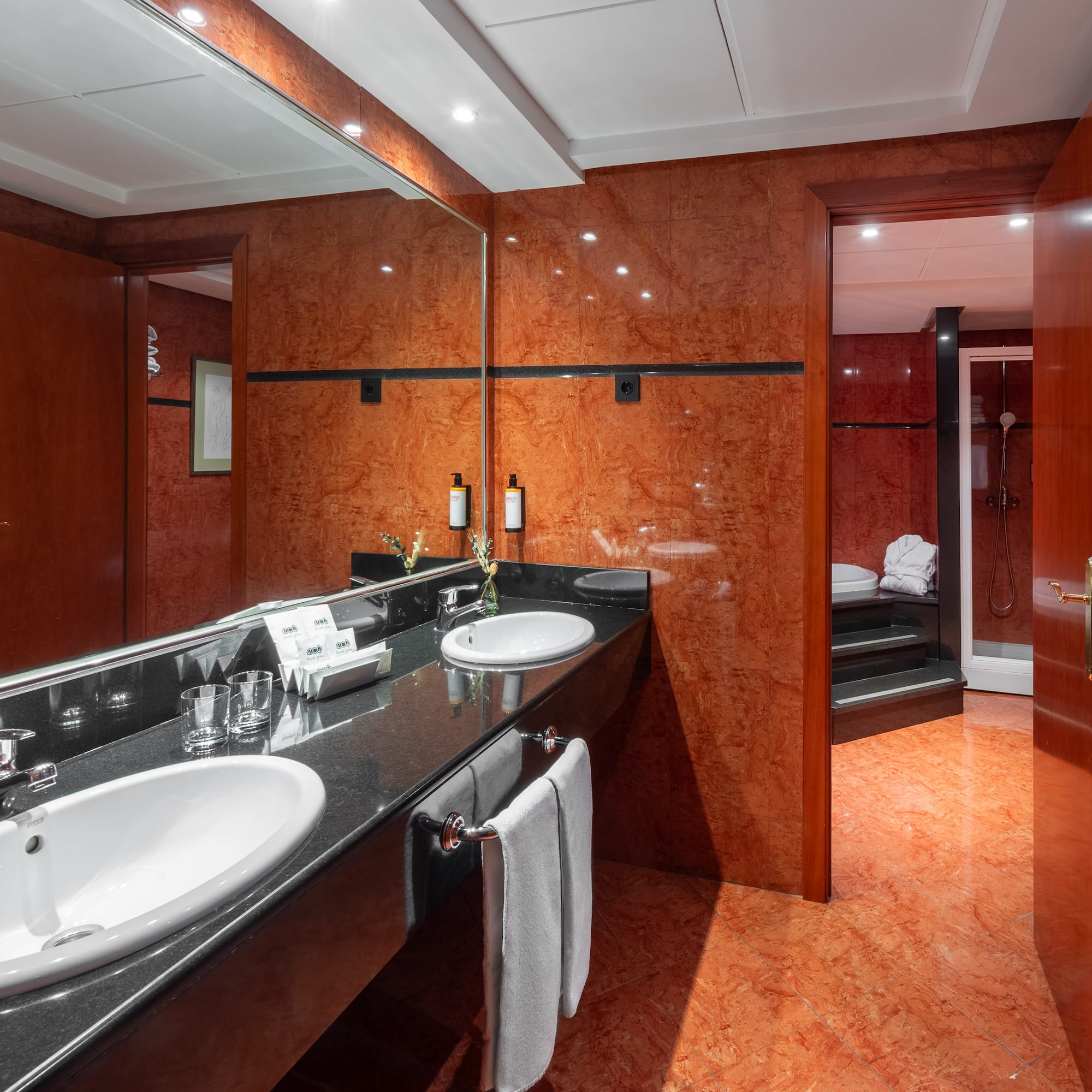 a bathroom with a marble countertop and a large mirror