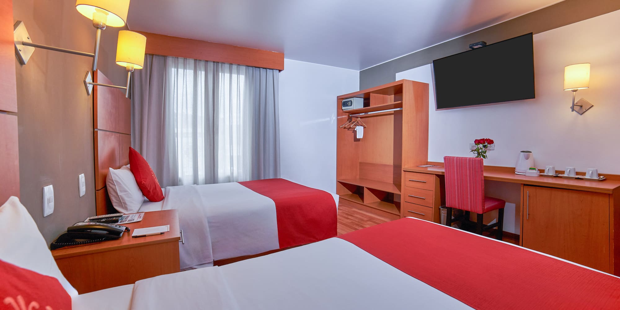 a room with two beds and a tv