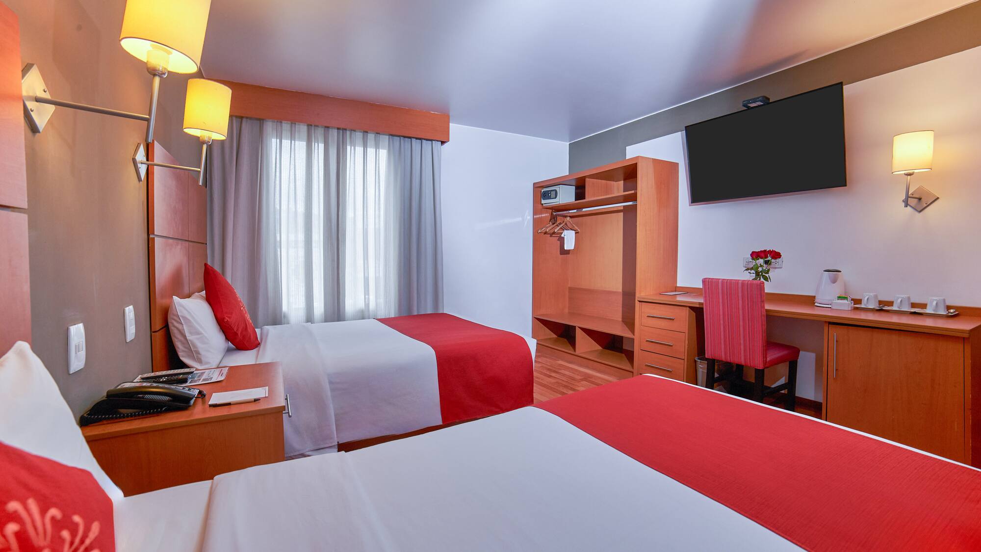a room with two beds and a tv