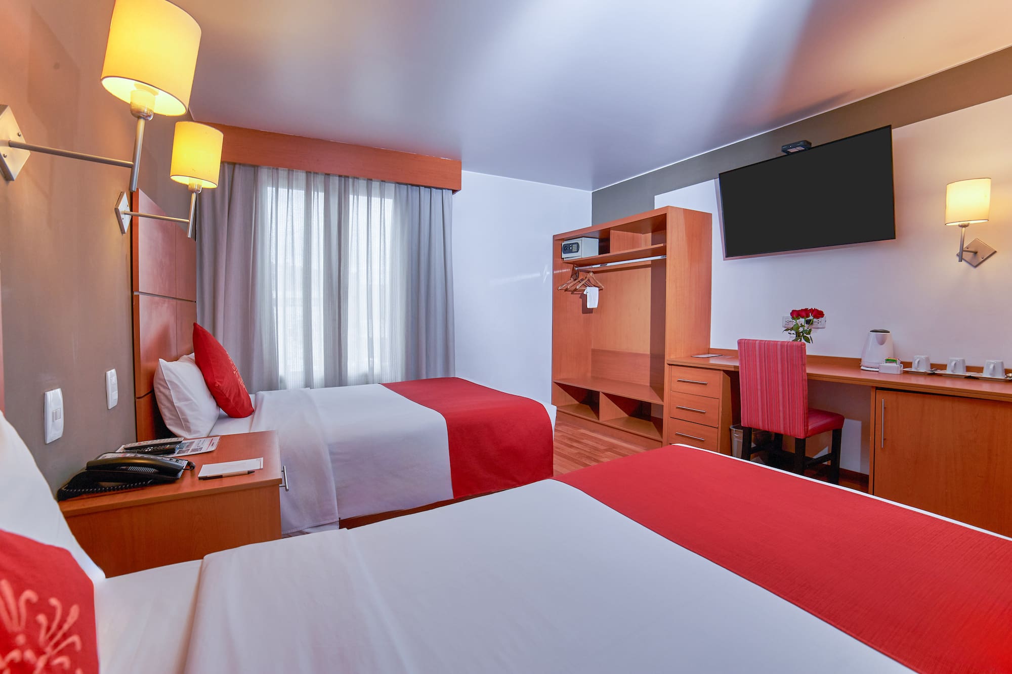 a room with two beds and a tv