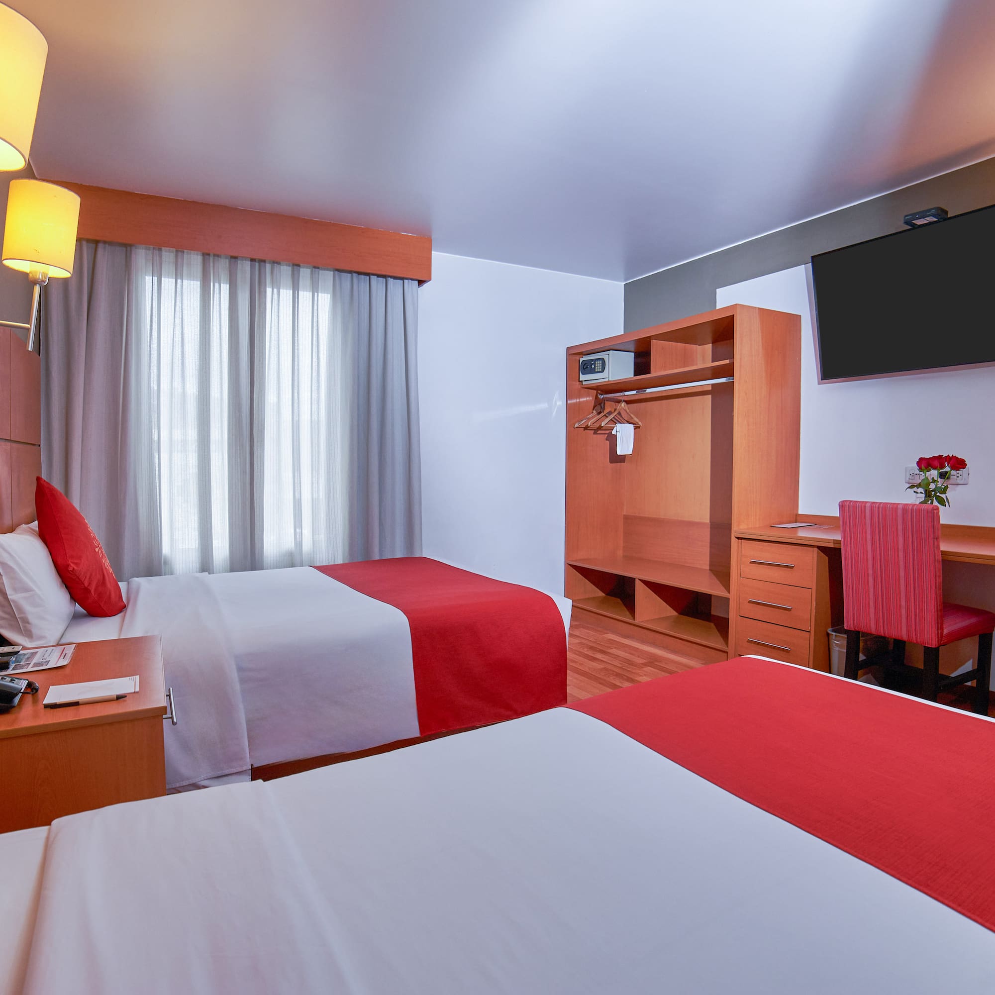 a room with two beds and a tv