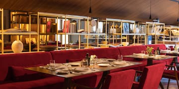 a restaurant with red chairs and tables