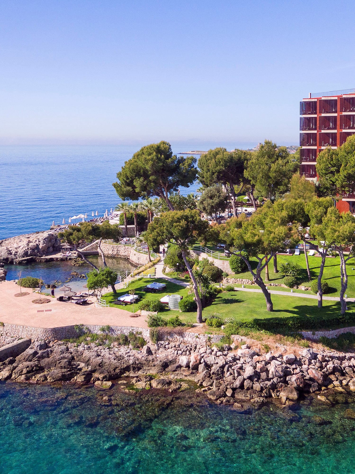 a building on a rocky island by the water