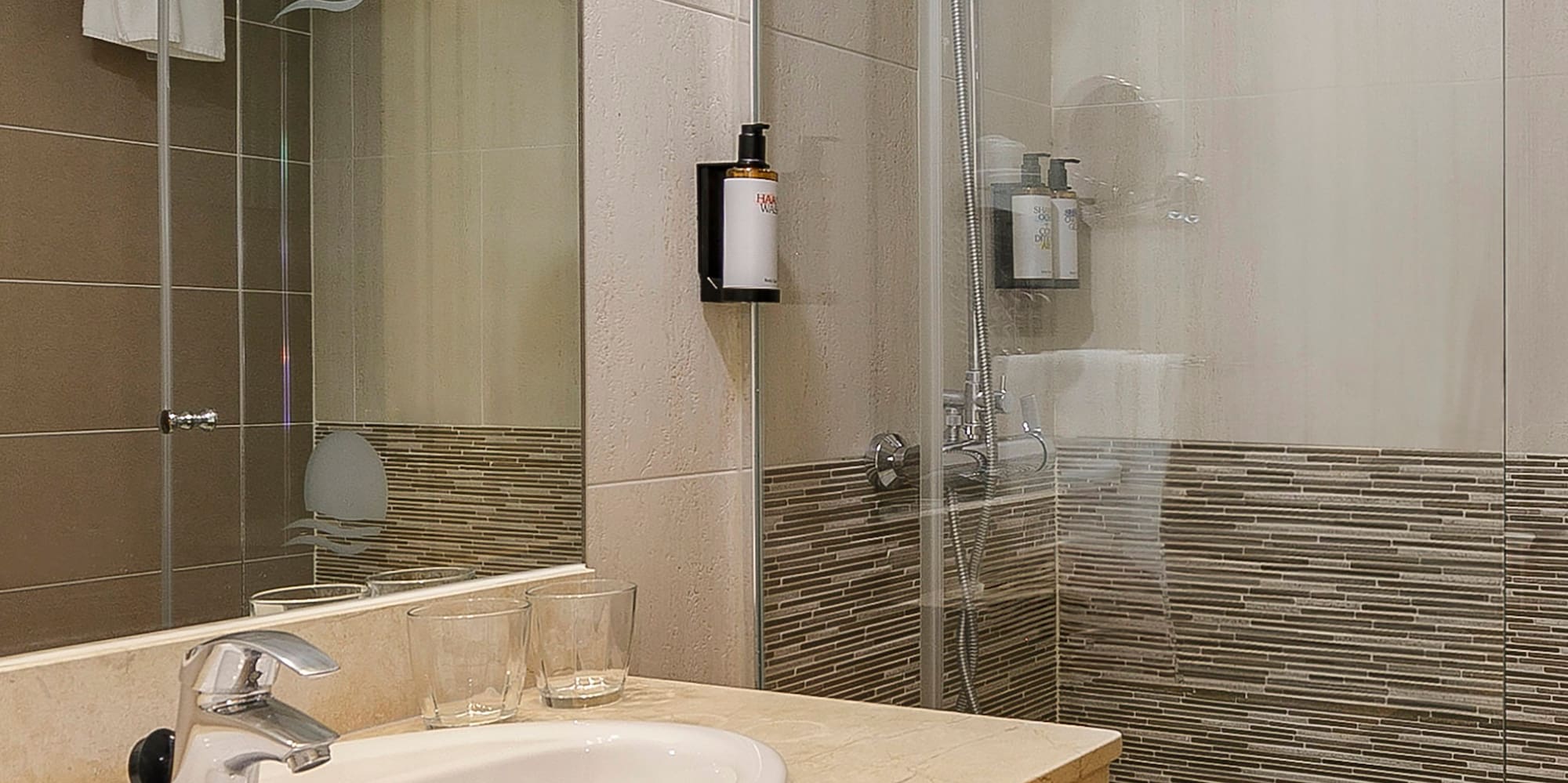 a bathroom with a shower and sink