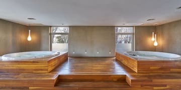 a room with wooden floors and a large tub