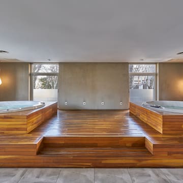 a room with wooden floors and a large tub