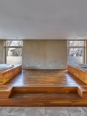 a room with wooden floors and a large tub