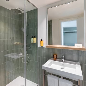 a bathroom with a shower and sink