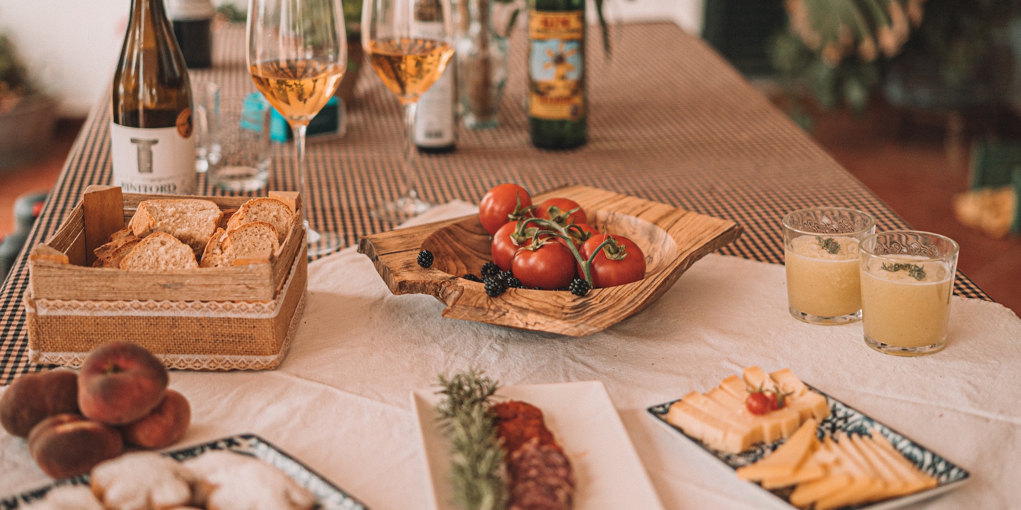 a table with food and wine glasses