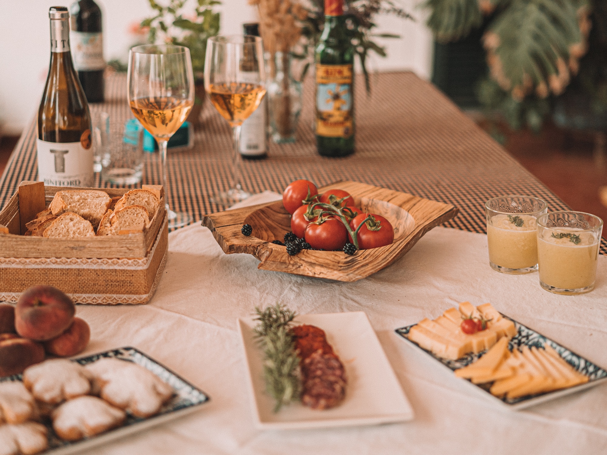 a table with food and wine glasses